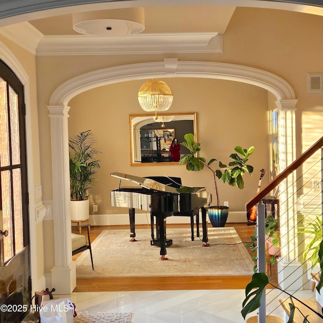 509 Westminster Cir, Greenville, NC 27858 - entryway featuring decorative columns, ornamental molding, wood finished floors, stairs, and arched walkways