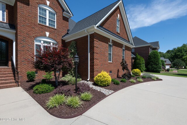 509 Westminster Cir, Greenville, NC 27858 - view of property exterior with brick siding, a shingled roof, and entry steps