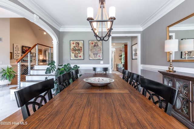 509 Westminster Cir, Greenville, NC 27858 - dining room featuring stairs, crown molding, arched walkways, decorative columns, and a chandelier