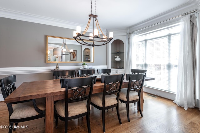 509 Westminster Cir, Greenville, NC 27858 - dining room featuring a chandelier, ornamental molding, and wood finished floors