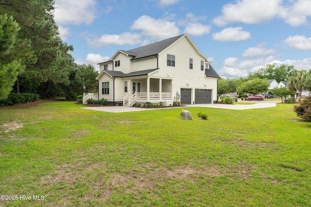 204 N Sea Lily Ct, Hampstead, NC 28443 - rear view of property featuring an attached garage, a yard, and concrete driveway