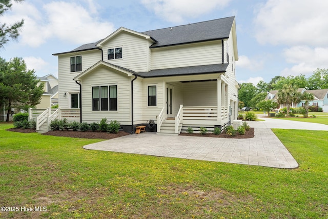 204 N Sea Lily Ct, Hampstead, NC 28443 - rear view of property featuring a lawn and roof with shingles