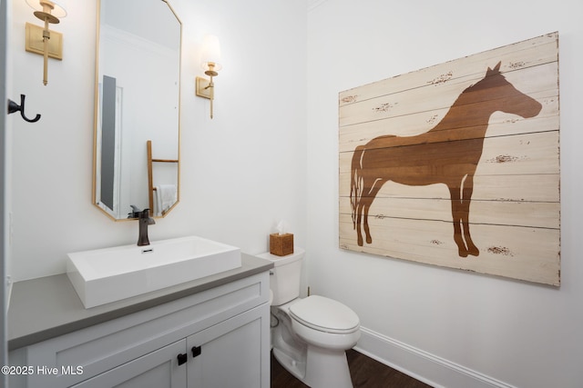 204 N Sea Lily Ct, Hampstead, NC 28443 - bathroom featuring vanity, toilet, wood finished floors, and baseboards