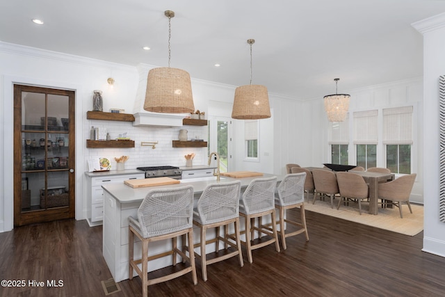 204 N Sea Lily Ct, Hampstead, NC 28443 - kitchen featuring open shelves, dark wood-style floors, crown molding, light countertops, and tasteful backsplash