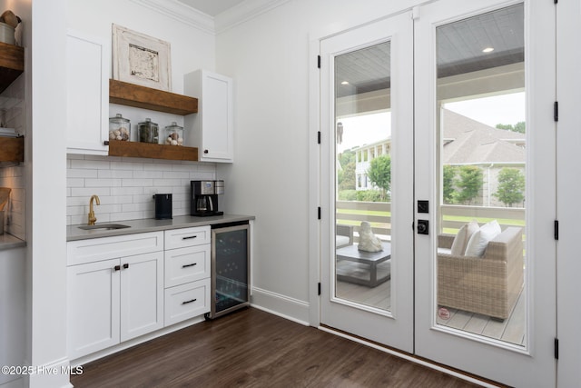 204 N Sea Lily Ct, Hampstead, NC 28443 - indoor wet bar with wine cooler, crown molding, dark wood-style floors, decorative backsplash, and french doors