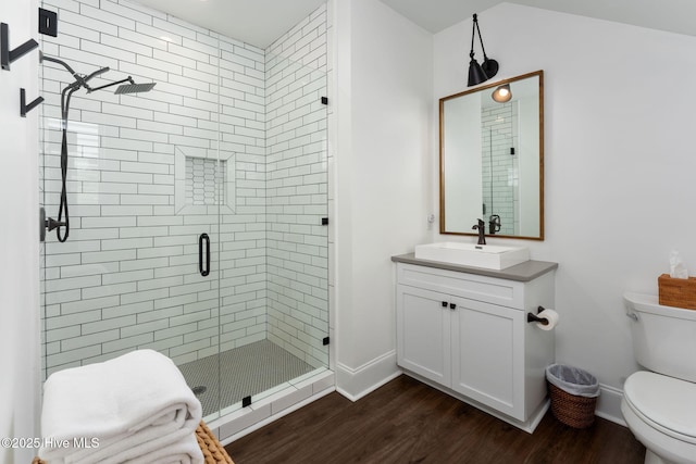 204 N Sea Lily Ct, Hampstead, NC 28443 - full bathroom featuring toilet, a stall shower, wood finished floors, vanity, and baseboards