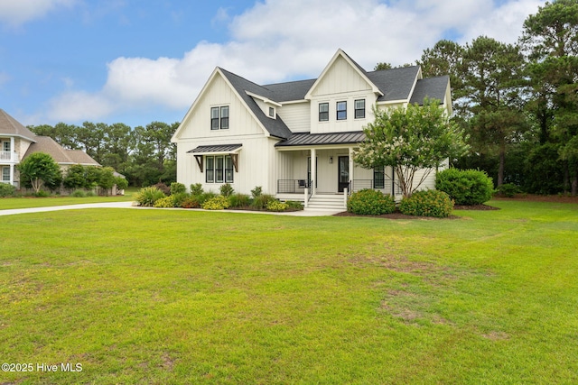 204 N Sea Lily Ct, Hampstead, NC 28443 - modern farmhouse style home featuring a standing seam roof, a porch, board and batten siding, metal roof, and a front yard