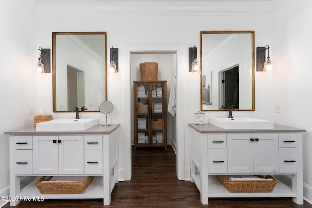 204 N Sea Lily Ct, Hampstead, NC 28443 - bathroom with two vanities, wood finished floors, ornamental molding, and baseboards