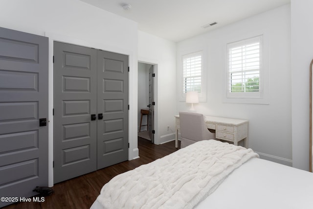 204 N Sea Lily Ct, Hampstead, NC 28443 - bedroom featuring a closet, dark wood-style floors, and baseboards