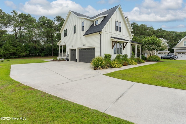 204 N Sea Lily Ct, Hampstead, NC 28443 - view of home's exterior featuring board and batten siding, an attached garage, concrete driveway, and a lawn