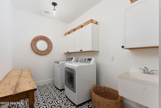 204 N Sea Lily Ct, Hampstead, NC 28443 - laundry area with washing machine and dryer and cabinet space