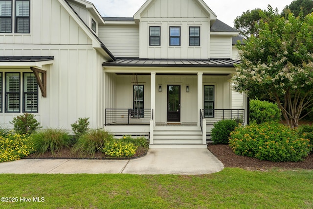 204 N Sea Lily Ct, Hampstead, NC 28443 - modern farmhouse with a standing seam roof, board and batten siding, a porch, and metal roof