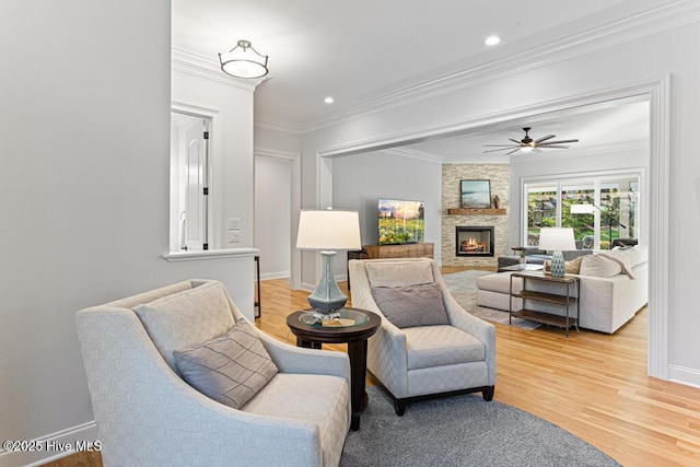 177 National Dr, Pinehurst, NC 28374 - living area with light wood-style flooring, a fireplace, baseboards, ornamental molding, and a ceiling fan