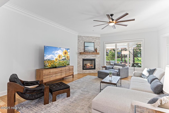 177 National Dr, Pinehurst, NC 28374 - living area featuring ornamental molding, wood finished floors, ceiling fan, a stone fireplace, and baseboards