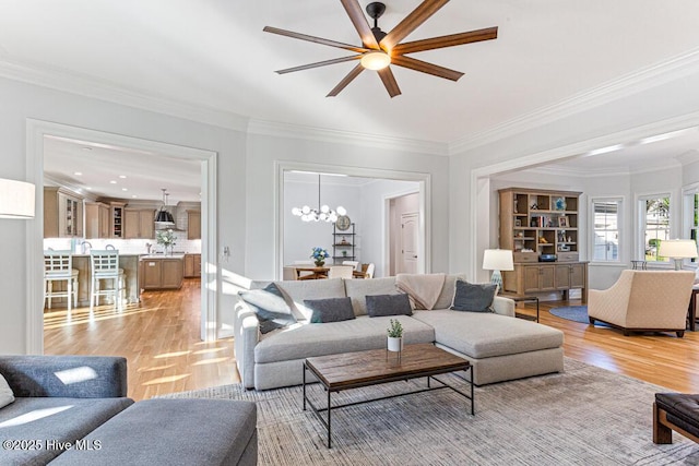 177 National Dr, Pinehurst, NC 28374 - living room with light wood finished floors, ornamental molding, ceiling fan, and a chandelier