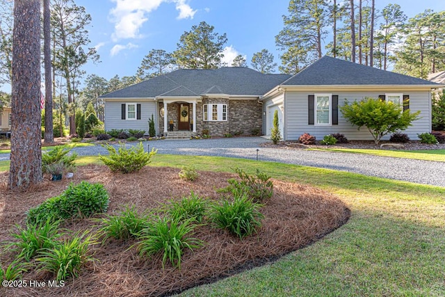 177 National Dr, Pinehurst, NC 28374 - view of front facade featuring a garage, curved driveway, a front yard, and stone siding