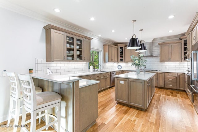 177 National Dr, Pinehurst, NC 28374 - kitchen featuring wall chimney range hood, a sink, stainless steel dishwasher, a peninsula, and a breakfast bar