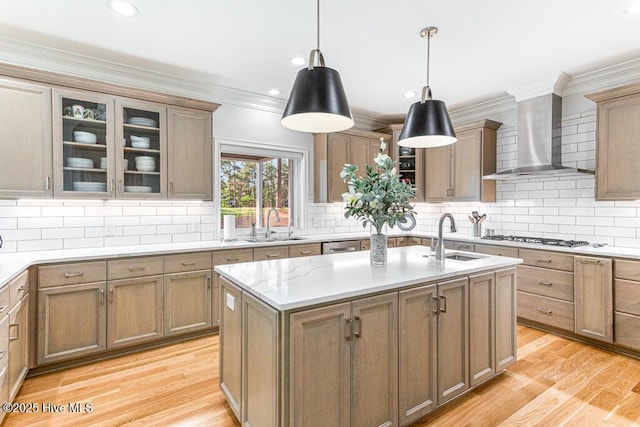 177 National Dr, Pinehurst, NC 28374 - kitchen featuring a sink, wall chimney range hood, light wood-style flooring, decorative backsplash, and crown molding