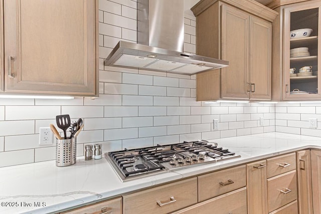 177 National Dr, Pinehurst, NC 28374 - kitchen with wall chimney exhaust hood, stainless steel gas stovetop, glass insert cabinets, and decorative backsplash