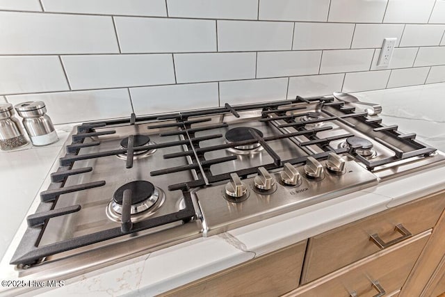 177 National Dr, Pinehurst, NC 28374 - kitchen view of stainless steel gas cooktop, backsplash, and light countertops