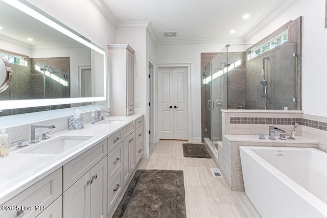 177 National Dr, Pinehurst, NC 28374 - bathroom featuring a garden tub, a stall shower, double vanity, ornamental molding, and recessed lighting