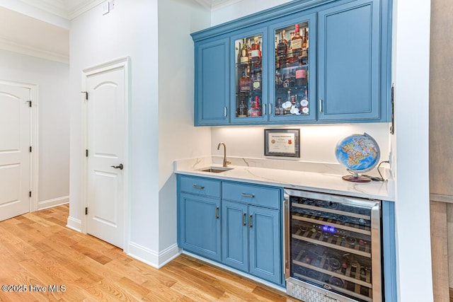 177 National Dr, Pinehurst, NC 28374 - indoor wet bar featuring beverage cooler, ornamental molding, light wood-type flooring, and baseboards