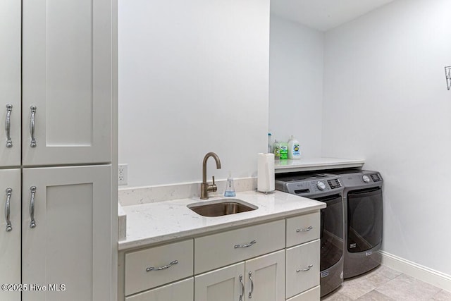 177 National Dr, Pinehurst, NC 28374 - laundry room featuring washing machine and clothes dryer, cabinet space, and baseboards