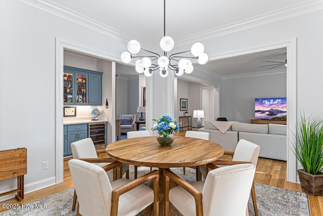 177 National Dr, Pinehurst, NC 28374 - dining space with beverage cooler, a bar, light wood-type flooring, ornamental molding, and a chandelier