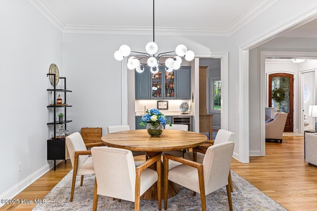 177 National Dr, Pinehurst, NC 28374 - dining space featuring light wood-style flooring, a chandelier, crown molding, and baseboards