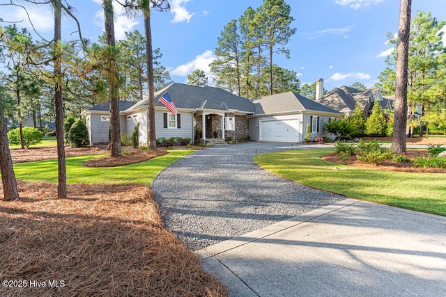 177 National Dr, Pinehurst, NC 28374 - ranch-style home featuring gravel driveway, an attached garage, and a front yard