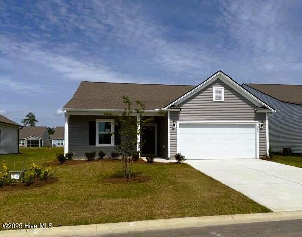285 Hawks Run Dr Unit 4068, Carolina Shores, NC 28467 - view of front of property featuring a garage, driveway, and a front lawn