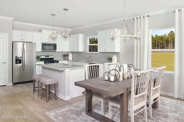 285 Hawks Run Dr Unit 4068, Carolina Shores, NC 28467 - kitchen featuring appliances with stainless steel finishes, a chandelier, plenty of natural light, and crown molding