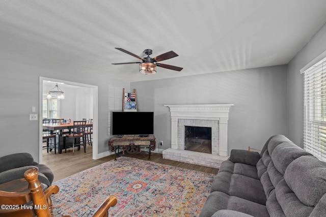 815 Gadwell Loop, Jacksonville, NC 28540 - living area featuring healthy amount of natural light, ceiling fan, wood finished floors, and a brick fireplace