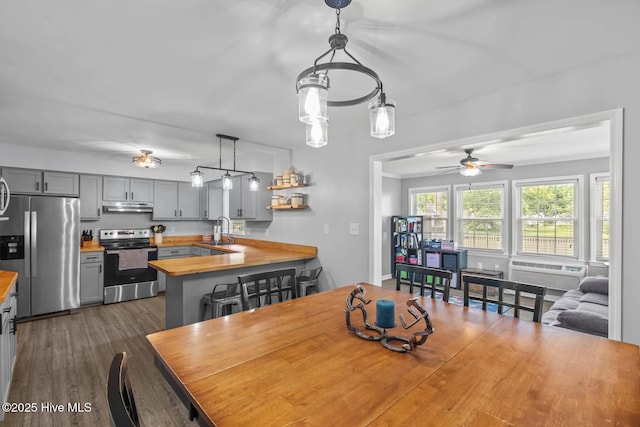 815 Gadwell Loop, Jacksonville, NC 28540 - dining area featuring ceiling fan, a wall mounted AC, and dark wood finished floors