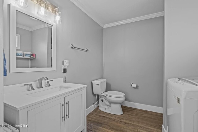815 Gadwell Loop, Jacksonville, NC 28540 - bathroom with washer / clothes dryer, crown molding, vanity, toilet, and wood finished floors