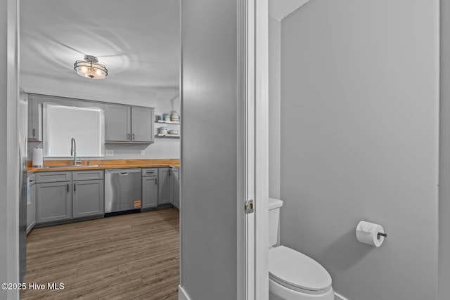 815 Gadwell Loop, Jacksonville, NC 28540 - bathroom featuring toilet, baseboards, vanity, and wood finished floors