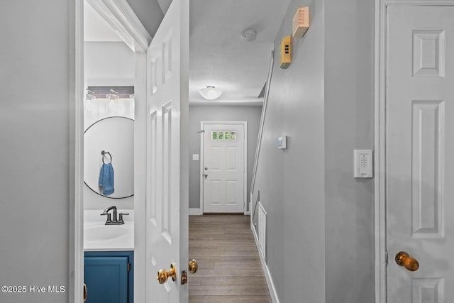 815 Gadwell Loop, Jacksonville, NC 28540 - corridor with a sink, dark wood-style floors, and baseboards