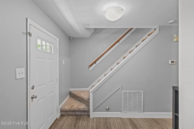 815 Gadwell Loop, Jacksonville, NC 28540 - entryway featuring wood finished floors, stairs, and baseboards