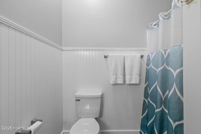815 Gadwell Loop, Jacksonville, NC 28540 - bathroom with toilet, curtained shower, and wainscoting