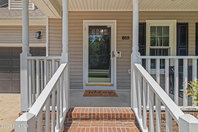 815 Gadwell Loop, Jacksonville, NC 28540 - view of exterior entry featuring covered porch and a garage