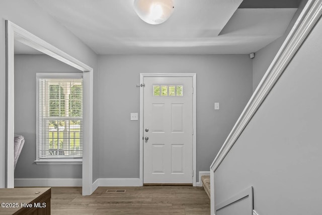 815 Gadwell Loop, Jacksonville, NC 28540 - entryway with healthy amount of natural light, wood finished floors, baseboards, and stairway