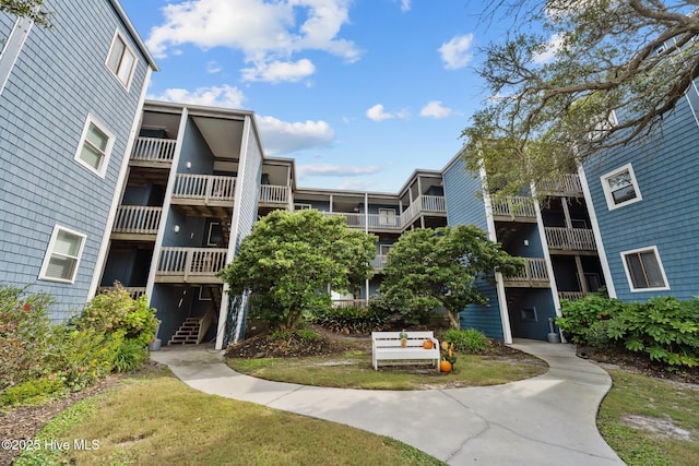 view of apartment building / complex featuring stairs