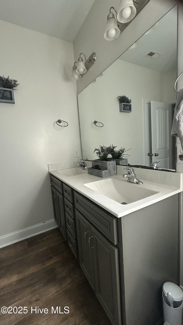 87 Strut Way, Rocky Point, NC 28457 - bathroom featuring wood finished floors, double vanity, and baseboards