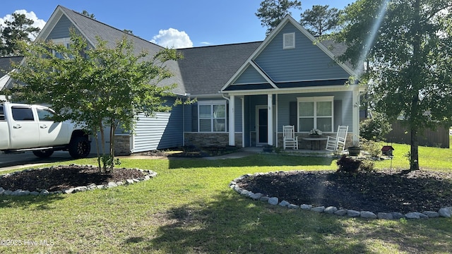 87 Strut Way, Rocky Point, NC 28457 - view of front of home featuring a porch, stone siding, and a front yard