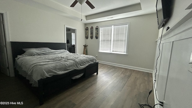 87 Strut Way, Rocky Point, NC 28457 - bedroom featuring a raised ceiling, baseboards, dark wood finished floors, and ceiling fan