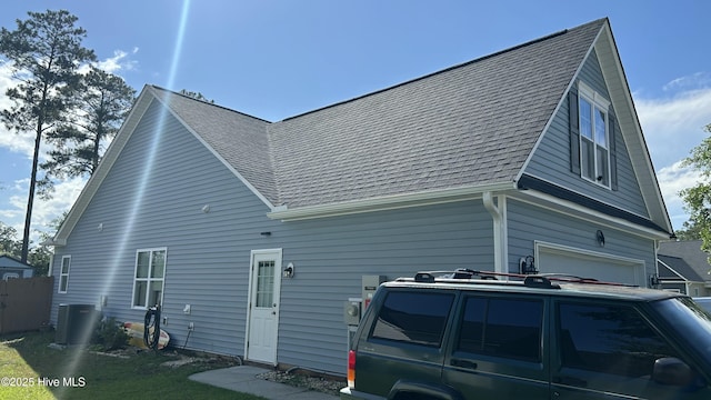 87 Strut Way, Rocky Point, NC 28457 - view of side of property with central AC, roof with shingles, and an attached garage
