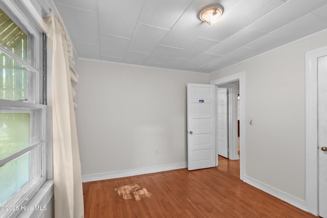 1704 Charlotte Ave, Kinston, NC 28501 - empty room featuring ornamental molding, wood finished floors, plenty of natural light, and baseboards