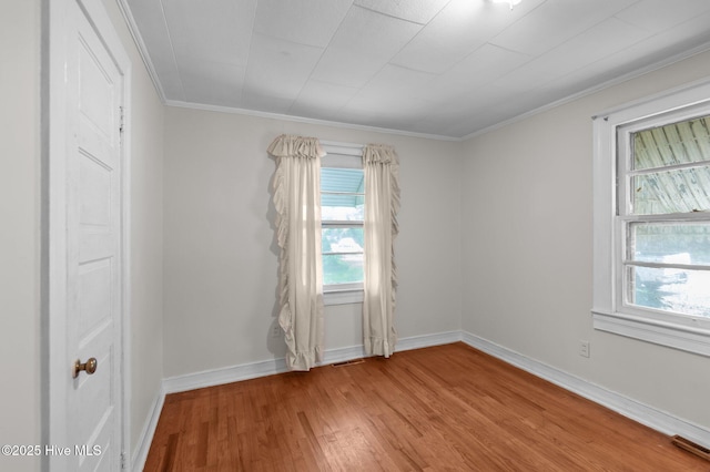 1704 Charlotte Ave, Kinston, NC 28501 - unfurnished room featuring healthy amount of natural light, wood finished floors, ornamental molding, and baseboards