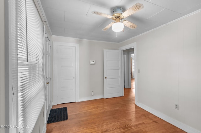 1704 Charlotte Ave, Kinston, NC 28501 - unfurnished bedroom featuring wood finished floors, baseboards, a ceiling fan, and crown molding