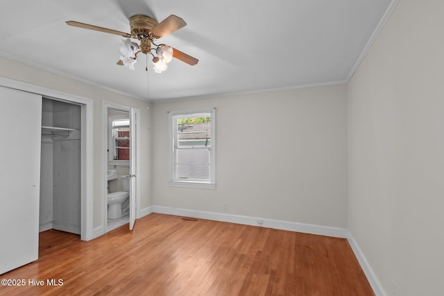 1704 Charlotte Ave, Kinston, NC 28501 - unfurnished bedroom featuring light wood finished floors, baseboards, crown molding, a closet, and a ceiling fan
